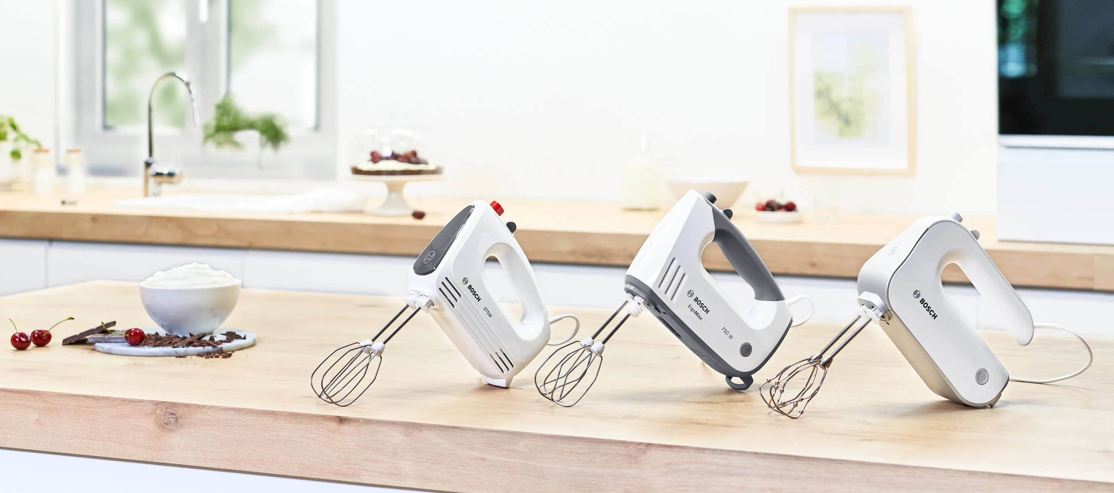 Hand mixers stood up on a kitchen countertop